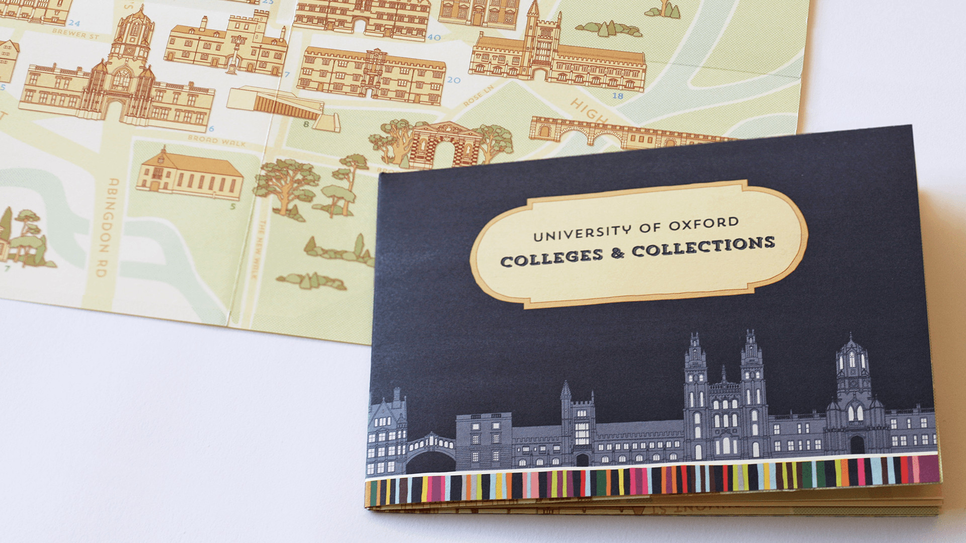 Folded map titled University of Oxford colleges and collections with dark blue cover next to an excerpt of an illustrated map of Oxford showing Abingdon Road and the Botanical Gardens