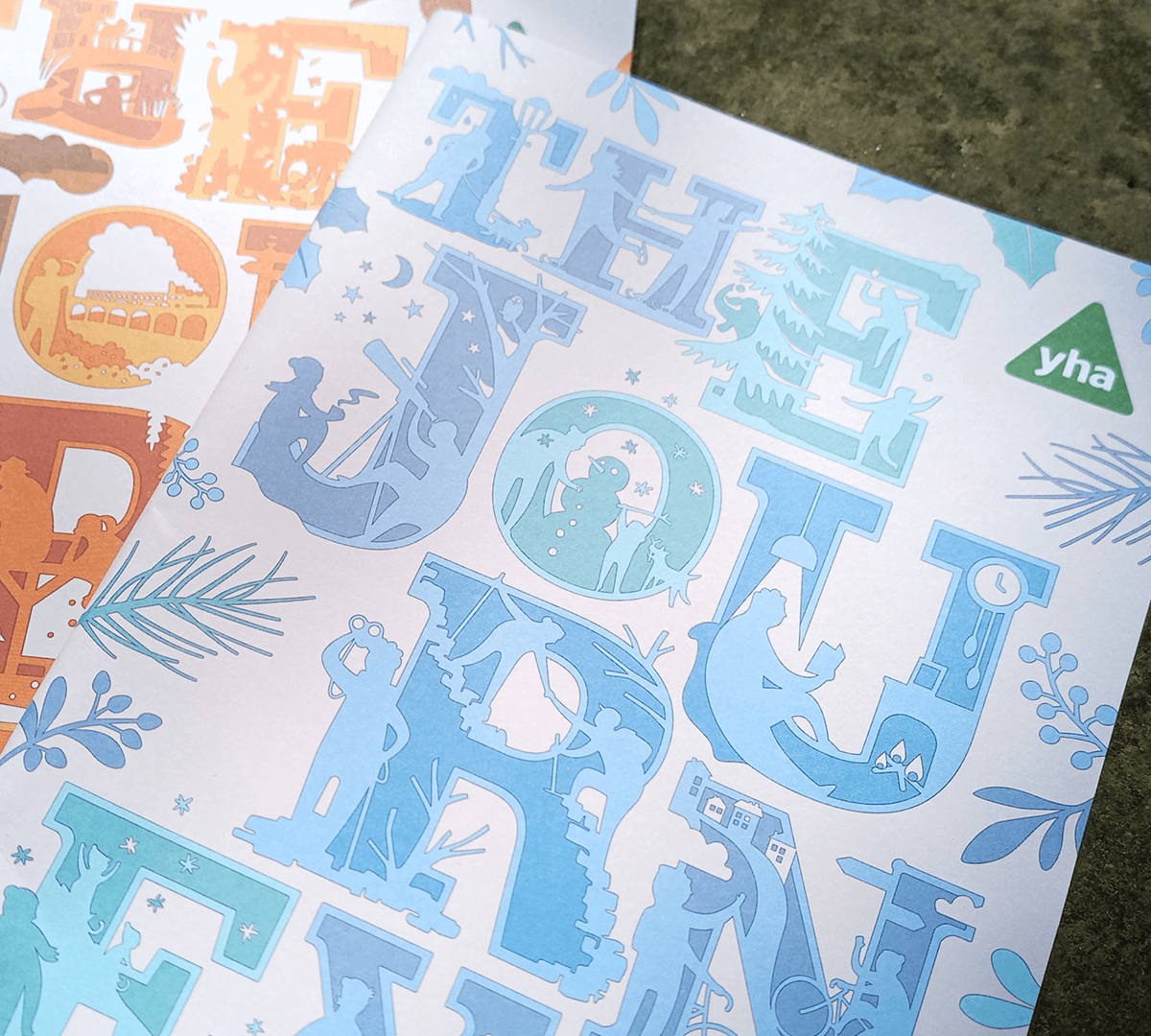 Close-up of two example covers of The Journey magazine showing the title in large illustrated letters